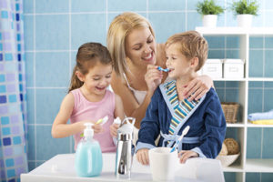 Smiling Family Brushing their teeth together